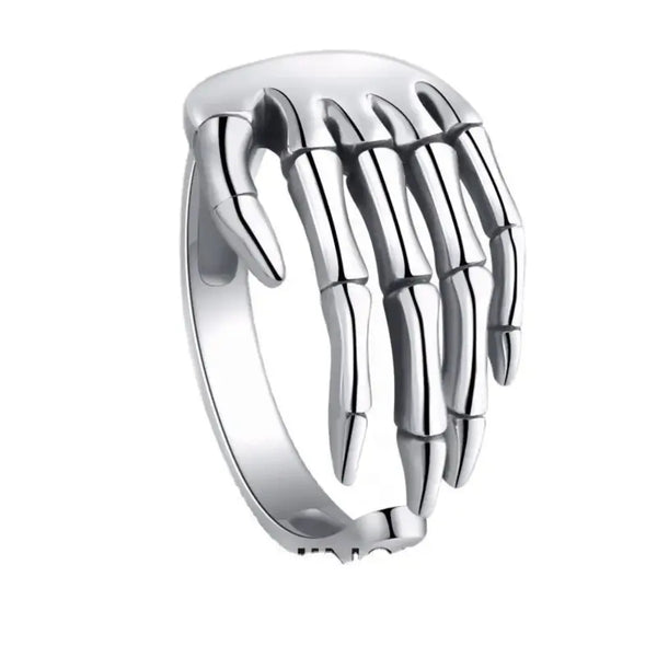 Silver skeleton hand ring on a white background