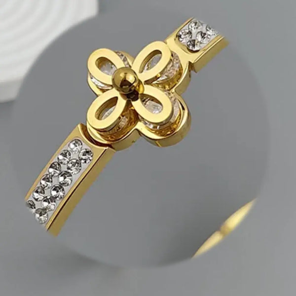 Gold pendant with diamond accents on a gray background