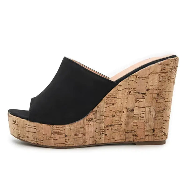 Black wedge sandal with cork wedge on a white background