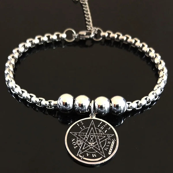 Silver beaded bracelet with a pentagram pendant on a black background
