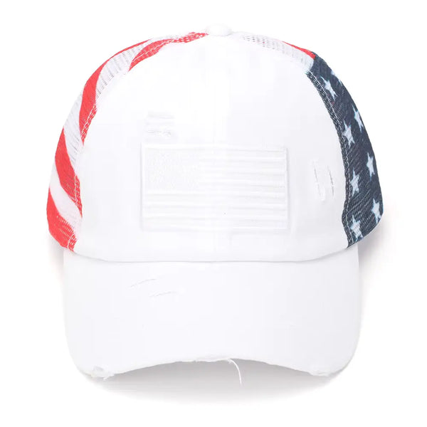A distressed trucker-style baseball cap featuring a white front panel and visor, with red and white stripes on the left side of the mesh back and a navy blue star pattern on the right side, set against a plain white background.