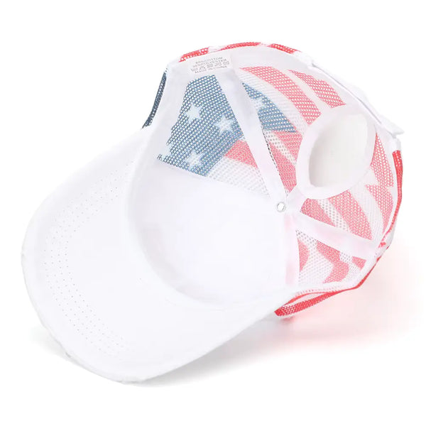 A white trucker-style cap with a red, white, and blue American flag pattern on the mesh back panels, shown on a clean white background.