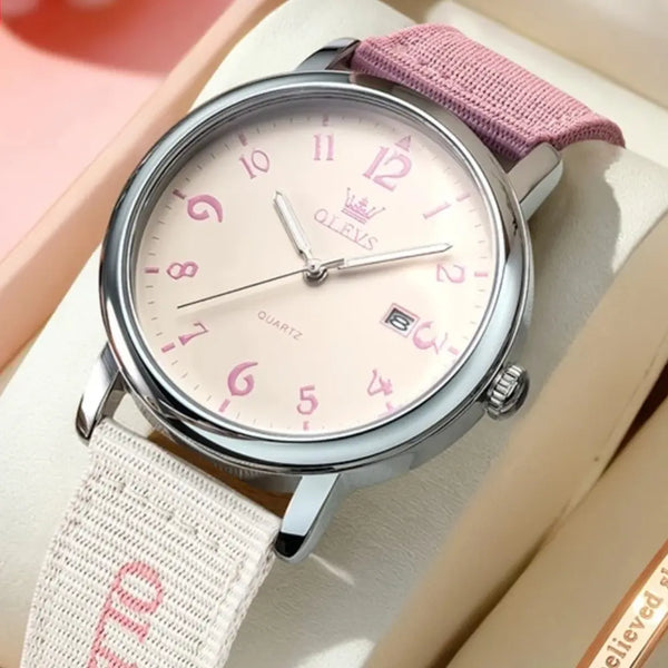 Watch with pink strap and white face on a light background