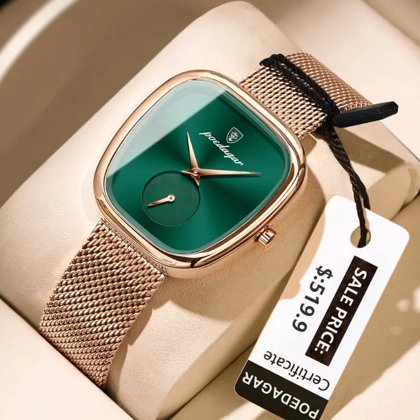 Watch with green face and gold mesh band on beige surface with price tag.