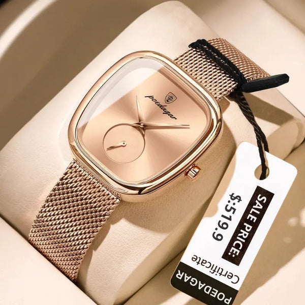 Rose gold watch with a mesh band on a beige surface, featuring a price tag.