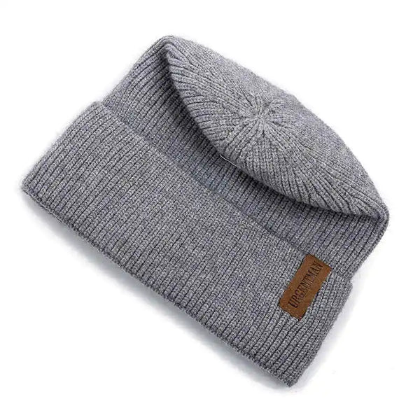 Gray knit beanie with a brand label on a white background