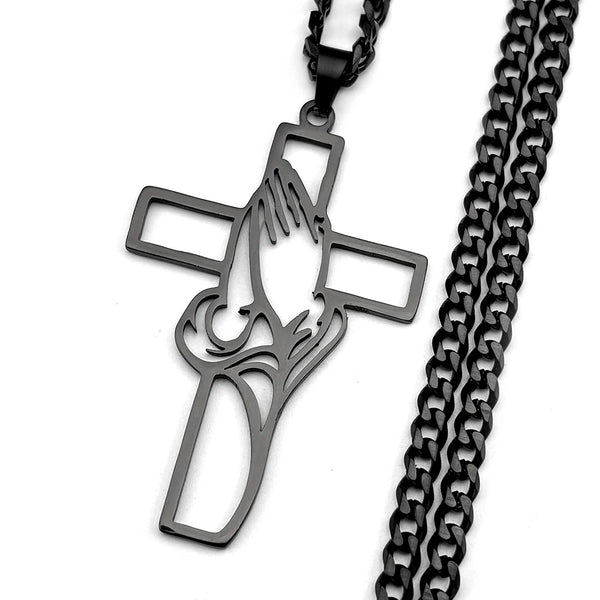 Black cross necklace with praying hands design on a white background
