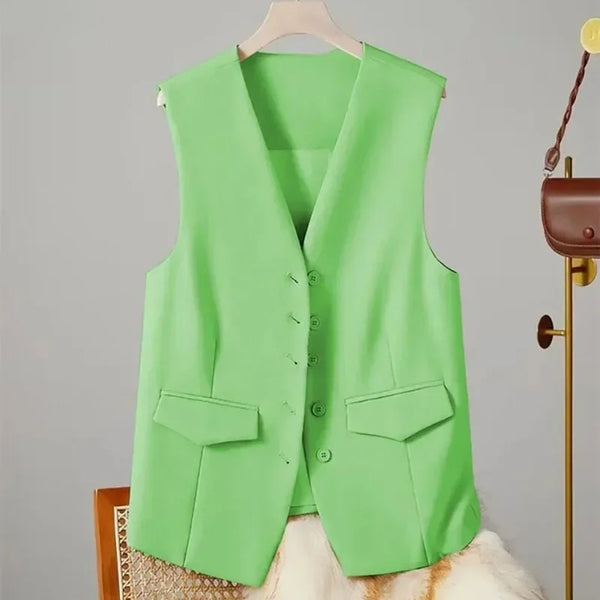 Green vest on a hanger against a gray background