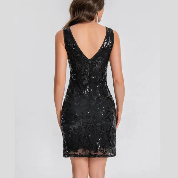 Black sequin dress on a plain background