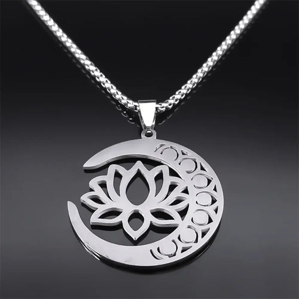 Silver necklace with a crescent moon and lotus flower pendant on a dark background