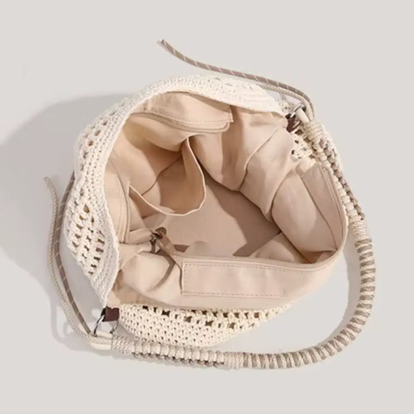 Beige woven handbag with a drawstring on a light gray background