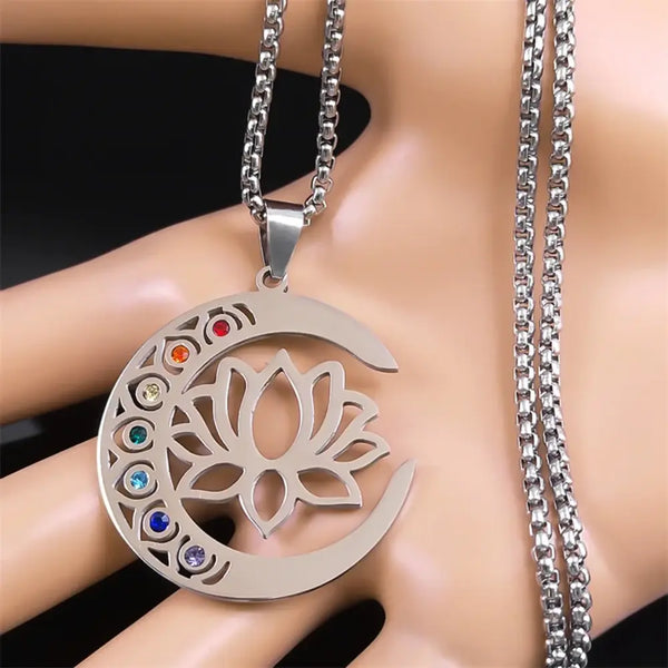Silver necklace with a crescent moon and lotus flower pendant on a mannequin.