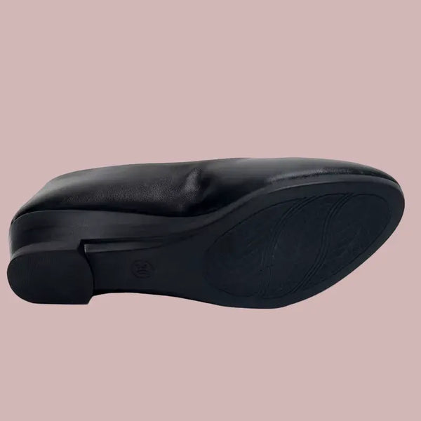 Black shoe sole on a pink background