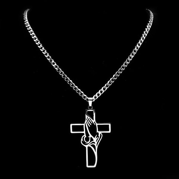 Silver necklace with a cross pendant on a black background