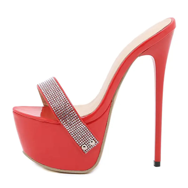 Red high-heeled shoe with a platform and rhinestone detail on a white background