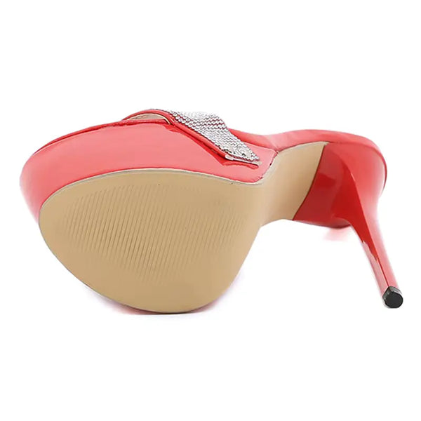Red high-heeled shoe with a beige sole on a white background