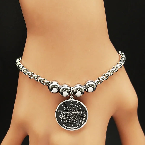 Silver beaded bracelet with a pentagram pendant on a model against a black background