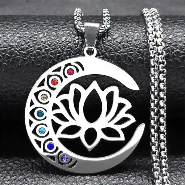 Silver necklace with a lotus flower pendant featuring colored stones on a textured surface.