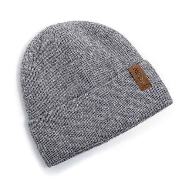 Gray knit beanie with a brown leather patch on a white background