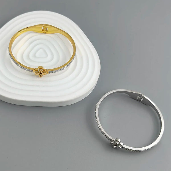 Gold and silver bracelets on a gray background