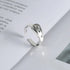 Silver ring with engraved text on an open book