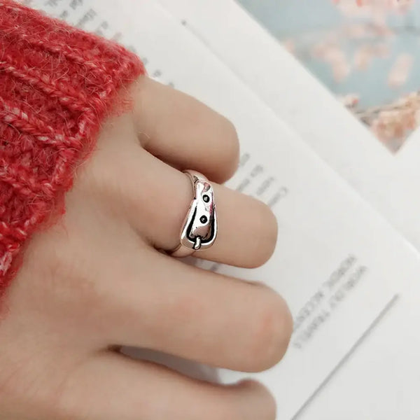Silver ring on a finger with a blurred background
