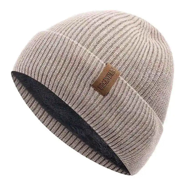 Beige knit beanie with a brown leather patch on a white background