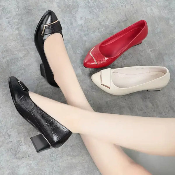 Black, red, and white shoes on a gray surface