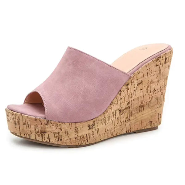 Pink wedge sandal with cork platform on a white background