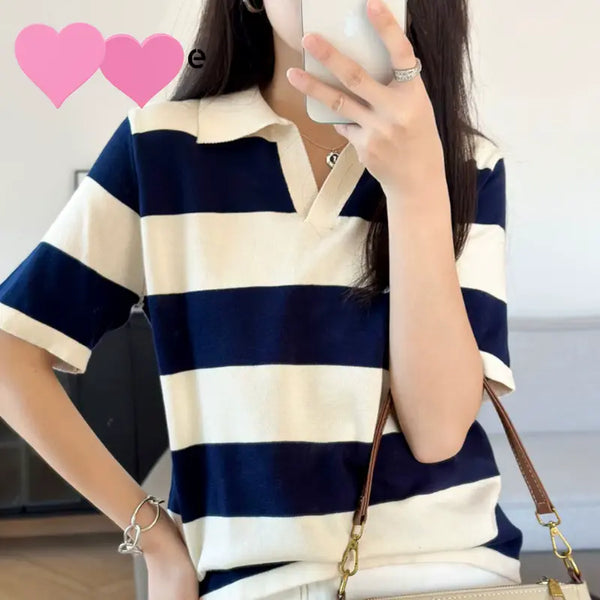 Person wearing a blue and white striped shirt with a blurred background