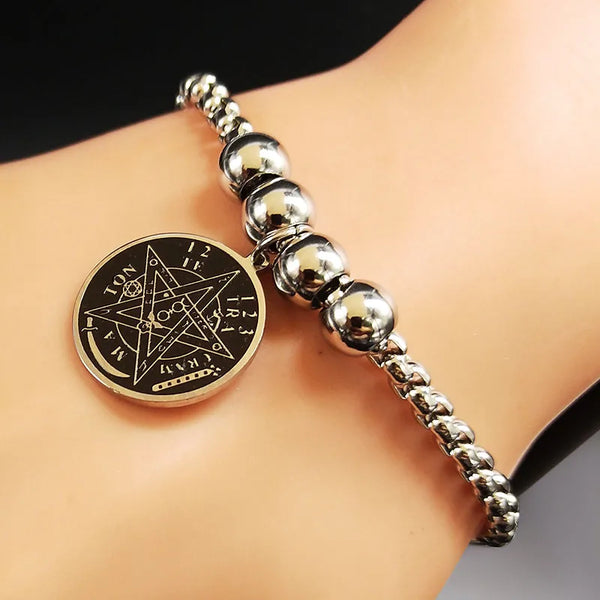 Bracelet with a pentagram pendant on a person's wrist