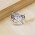 Silver ring with a pentacle design on a wooden surface