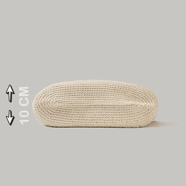 Beige woven oval ottoman on a light gray background with measurement label.