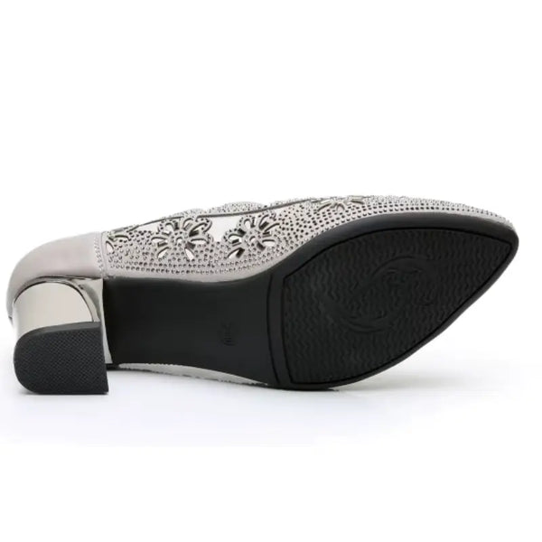 Silver high heel shoe with decorative pattern on a white background