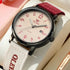 Watch with a red and beige strap on a light background