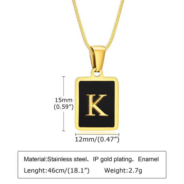 Gold necklace with a black square pendant featuring the letter 'K', showing measurements and material details.