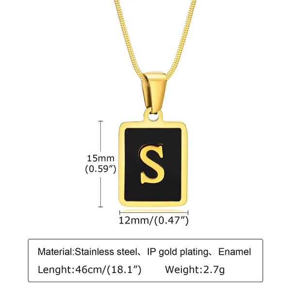 Gold necklace with a black square pendant featuring the letter 'S', showing measurements and material details.