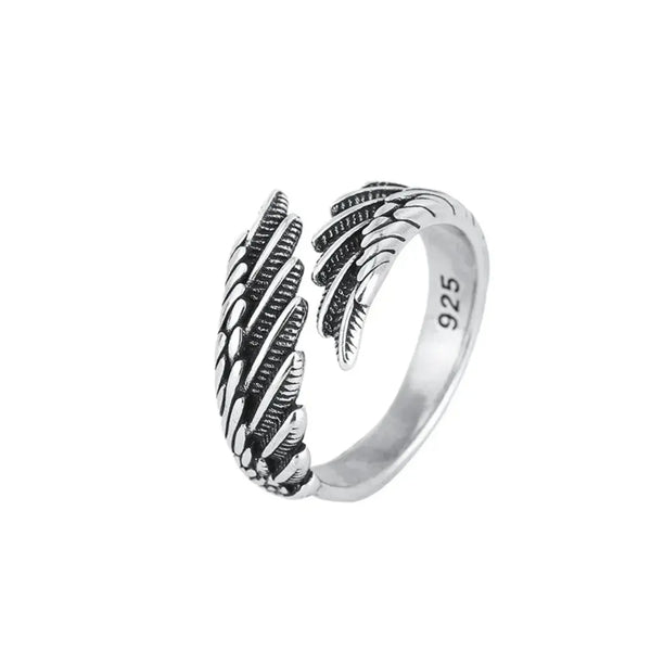Silver ring with feather design on a white background