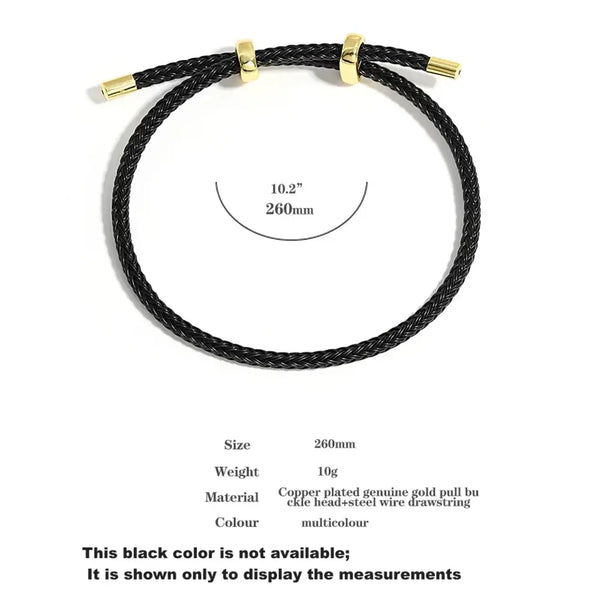 Black braided cord bracelet with gold-tone metal ends and a gold slide clasp, shown on a white background with size and material information printed below.