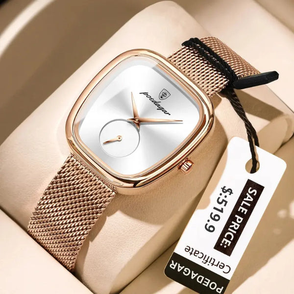 Rose gold watch with white face on a beige surface, featuring a sale tag.