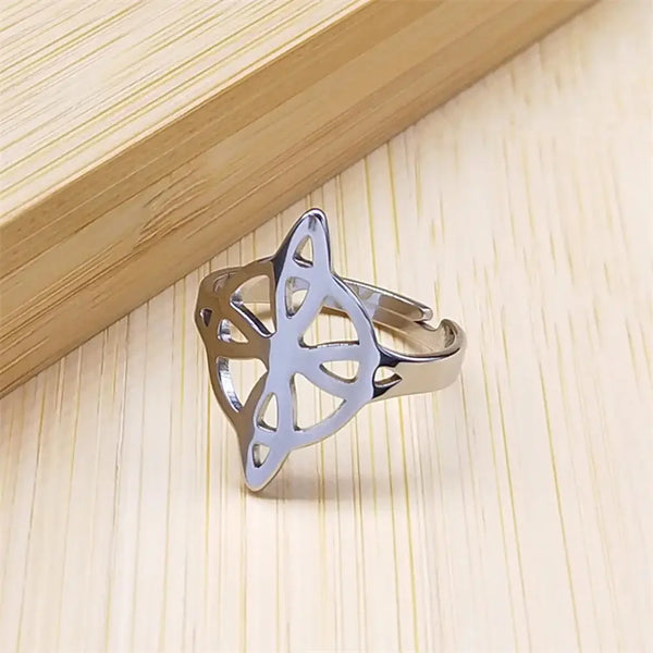 Silver ring with a unique design on a wooden surface