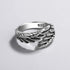 Silver winged ring with '925' stamp on a light gray background