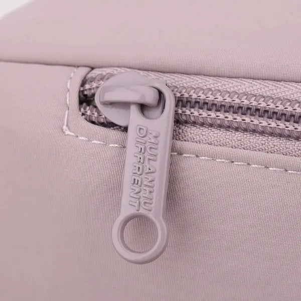 Close-up of a zipper on a gray bag with 'YULANWU' branding.