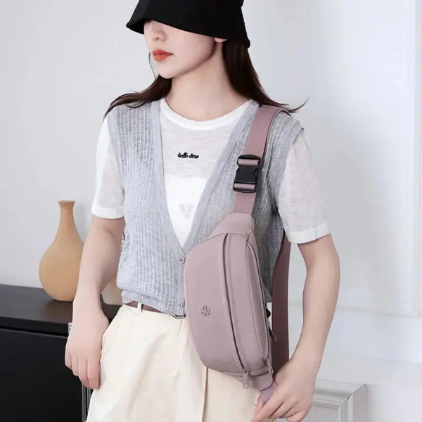 Woman wearing a light purple crossbody bag with a neutral background