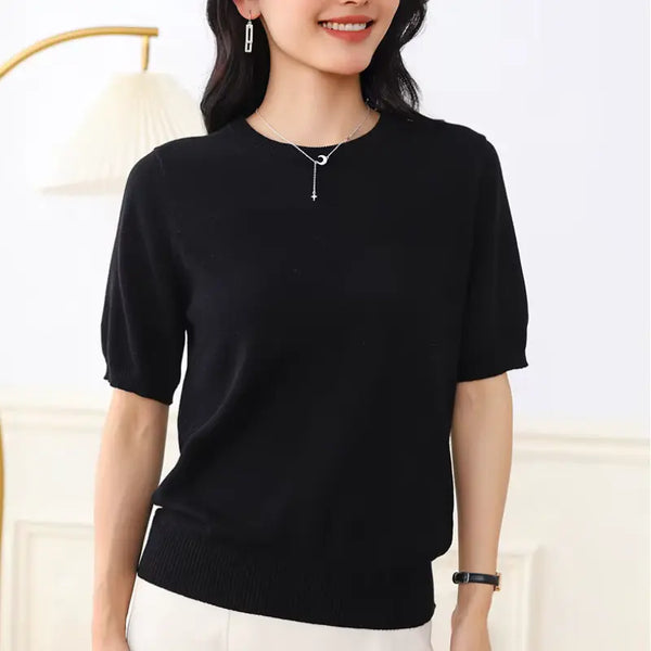 Woman wearing a black sweater against a white background