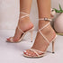 Beige high-heeled sandals with strappy design on a light background