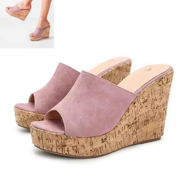 Pink wedge sandals with cork platforms on a white background