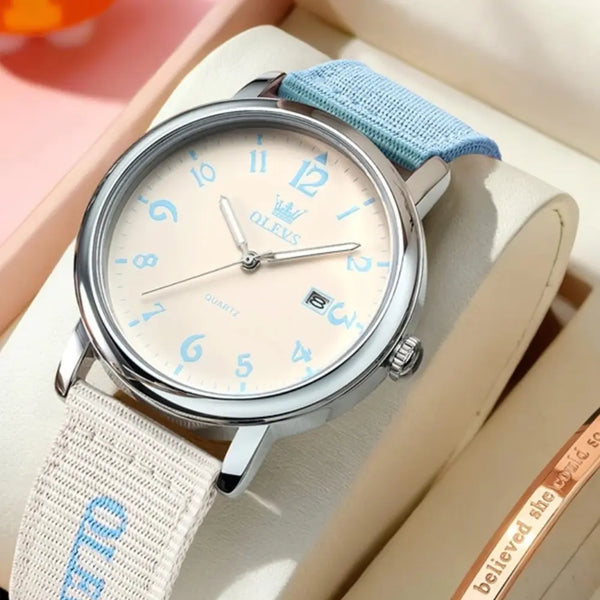 Watch with a blue strap on a beige surface