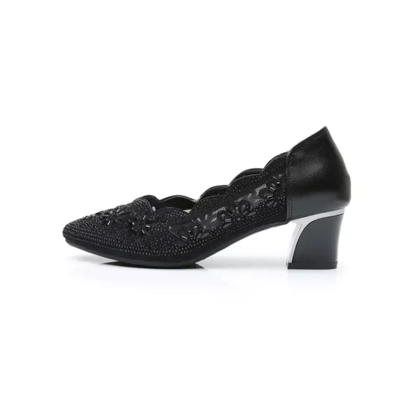 Black shoe with decorative pattern on a white background