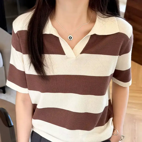 Person wearing a brown and white striped shirt indoors